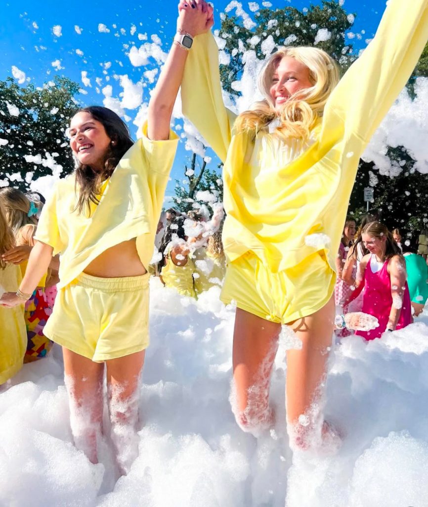 girls in yelow laughing in foam